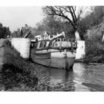 A cargo boat in the C and O Canal just after a lock.